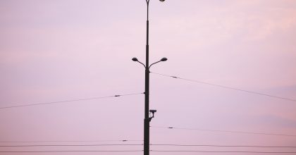 city light with camera against purple sunset sky