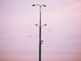 city light with camera against purple sunset sky